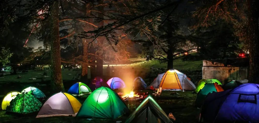 a group of tents lit up at night