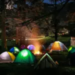 a group of tents lit up at night